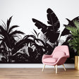 Black and white tropical jungle wallpaper creating dramatic impact in modern living room with minimal furniture
