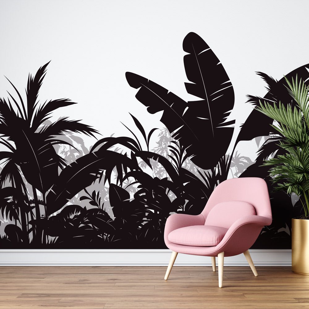 Black and white tropical jungle wallpaper creating dramatic impact in modern living room with minimal furniture
