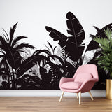 Black and white tropical jungle wallpaper creating dramatic impact in modern living room with minimal furniture