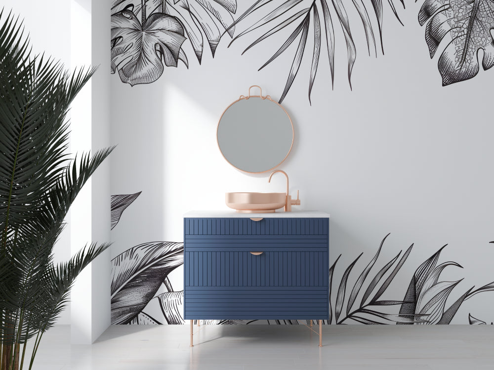 Black and white tropical leaf wallpaper creating a stunning accent wall in a modern living room