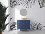 Black and white tropical leaf wallpaper creating a stunning accent wall in a modern living room