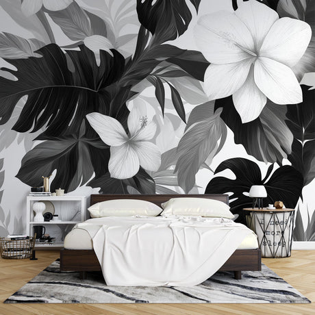 Black and white tropical wallpaper with Monstera leaves creating drama in a modern living room setting