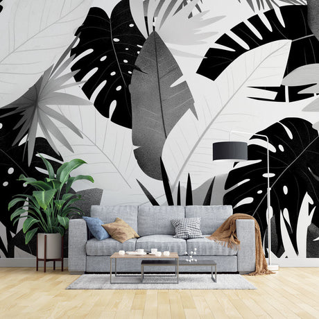 Black and white Monstera wallpaper in modern living room with minimal furniture and natural light