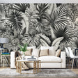 Black and white Monstera leaf wallpaper in a modern living room setting, creating a bold statement wall with dramatic contrast