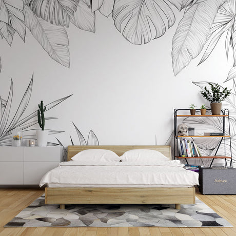 Black and white Monstera leaf wallpaper creating a stunning accent wall in a modern minimalist living room