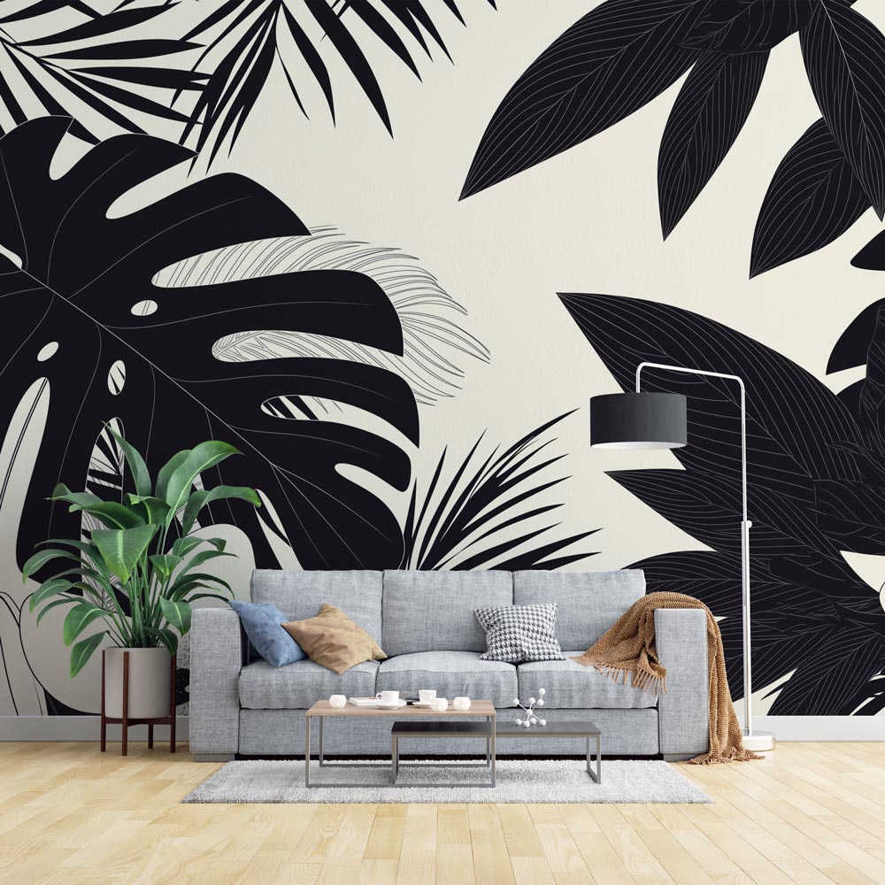Modern living room with Black and White Tropical Monstera Leaf Wallpaper creating dramatic accent wall against minimal furniture