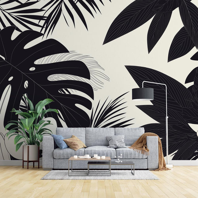 Modern living room with Black and White Tropical Monstera Leaf Wallpaper creating dramatic accent wall against minimal furniture