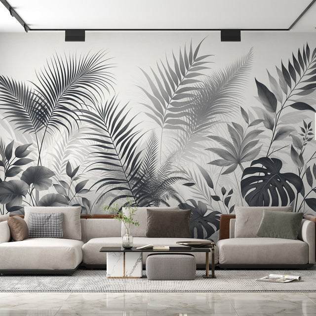 Black and white tropical leaf wallpaper creates drama in modern living room with gray sofa and natural light