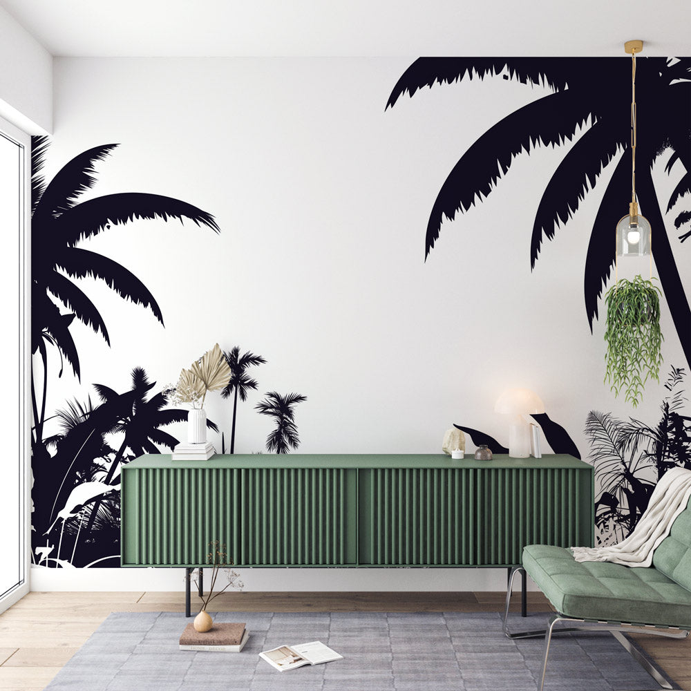 Black and white tropical palm wallpaper creating a dramatic feature wall in a modern living room with minimal furniture