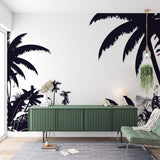 Black and white tropical palm wallpaper creating a dramatic feature wall in a modern living room with minimal furniture