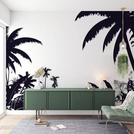 Black and white tropical palm wallpaper creating a dramatic feature wall in a modern living room with minimal furniture