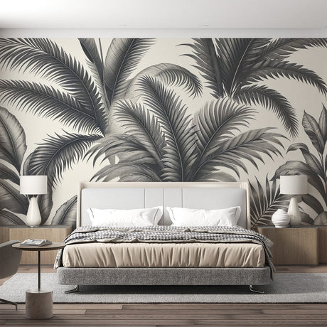 Black and white tropical palm leaf wallpaper creating a stunning focal point in a modern minimalist living room