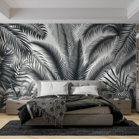 Black and white palm leaves wallpaper creating a modern statement wall in a bright living room setting