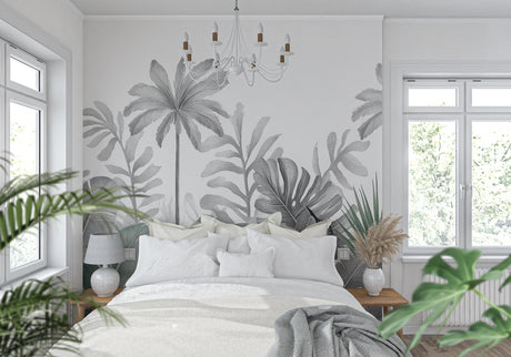 Black and white tropical palm leaf wallpaper in modern living room with gray sofa