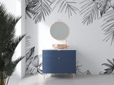 Black and white tropical palm leaf wallpaper in a bright modern living room setting with minimal furniture