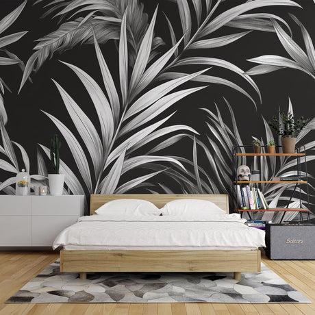 Black and white tropical palm leaf wallpaper in a modern minimalist living room with natural light and designer furniture