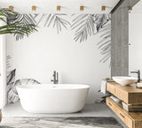 Monochrome palm leaves wallpaper creating depth in a contemporary bedroom with natural light