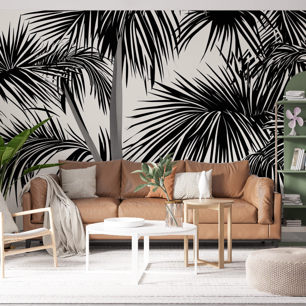 Black and white tropical palm leaf wallpaper creating dramatic impact in a modern living room with high ceilings
