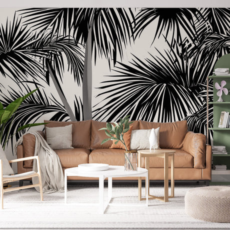 Black and white tropical palm leaf wallpaper creating dramatic impact in a modern living room with high ceilings