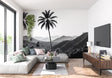 Black and white tropical palm wallpaper creating drama in modern living room setting