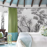 Monochrome palm leaf wallpaper mural in bedroom setting showing scale and depth