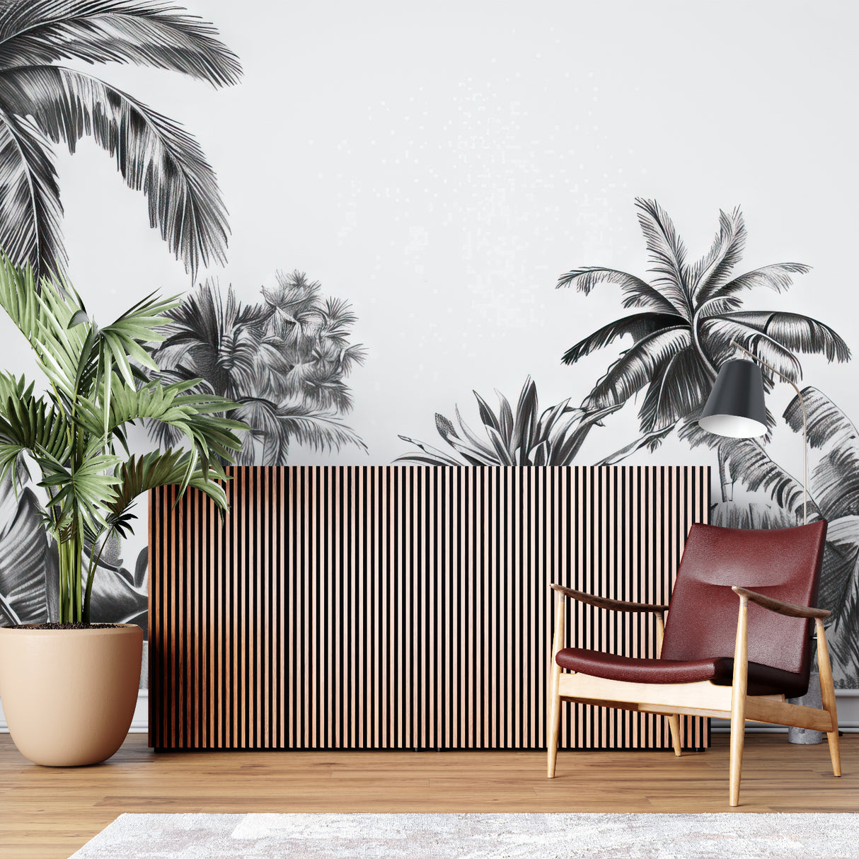 Black and white tropical palm mural creating drama in modern living room with grey sofa