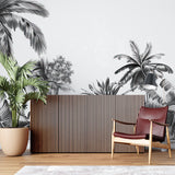 Black and white tropical palm mural creating drama in modern living room with grey sofa