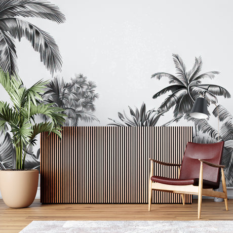 Black and white tropical palm mural creating drama in modern living room with grey sofa