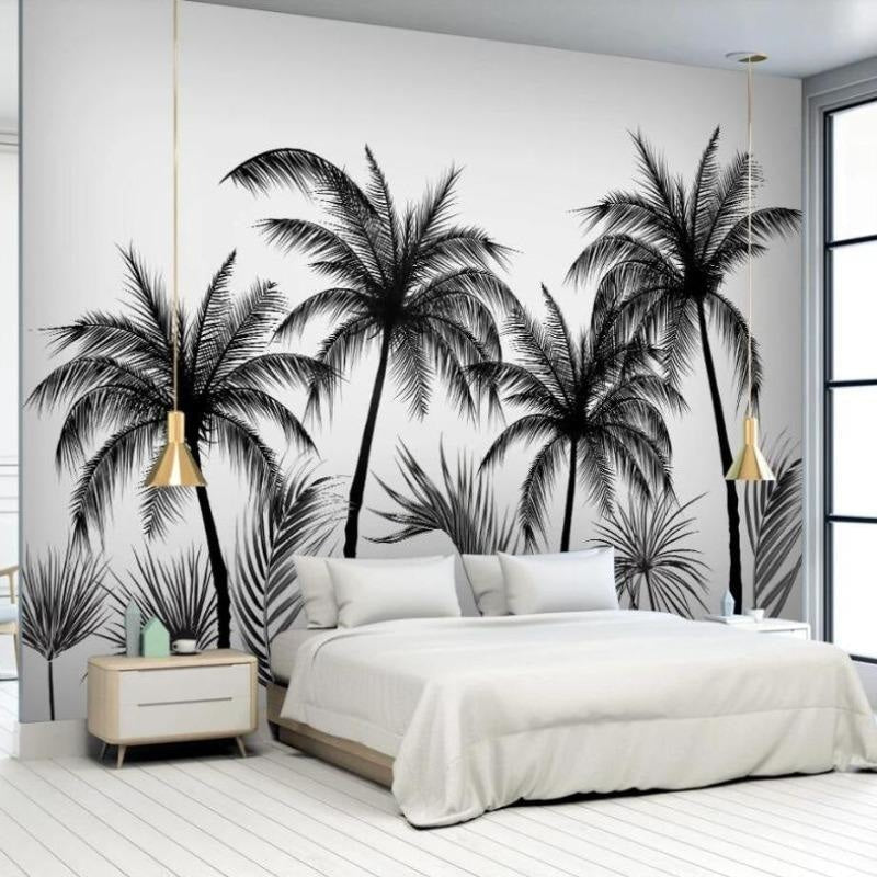 Black and white tropical palm tree wallpaper in a modern living room setting with minimalist furniture