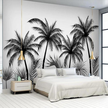 Black and white tropical palm tree wallpaper in a modern living room setting with minimalist furniture