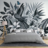 Tropical bird wallpaper creating dramatic impact in modern living room, black and white parrot design with blue accents