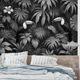 Black and white tropical jungle wallpaper with toucans creating drama in a modern living room