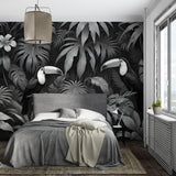 Dramatic toucan and monstera leaf wallpaper in a home office setting