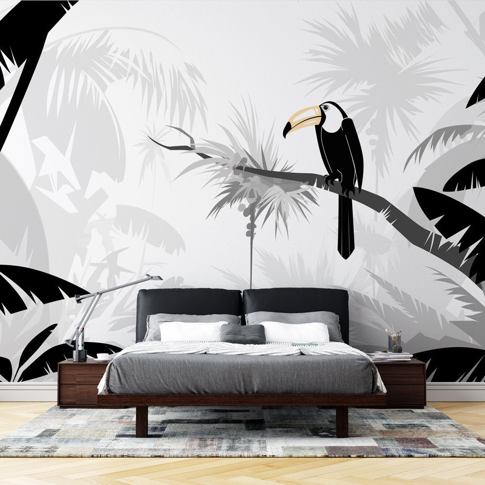 Tropical bird wallpaper with black and white toucan design creating drama in a modern living room with minimalist furniture