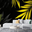 Tropical leaf wallpaper with yellow palm leaves on black background showcased in a modern living room setting