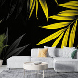 Tropical leaf wallpaper with yellow palm leaves on black background showcased in a modern living room setting