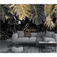 Tropical black and gold leaf wallpaper in modern living room showing dramatic marble effect and metallic accents