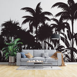 Tropical palm tree silhouette wallpaper creating drama in a modern living room with white sofa and minimal decor