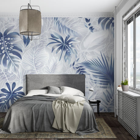 Modern living room with blue and white Monstera leaf wallpaper creating a fresh tropical atmosphere