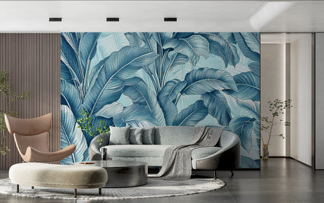 Tropical banana leaf wallpaper in blue tones creating a stunning accent wall in a modern living room