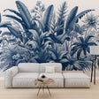 Blue tropical botanical wallpaper creating a serene atmosphere in a modern living room with white furniture
