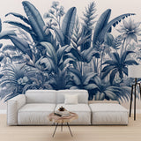 Blue tropical botanical wallpaper creating a serene atmosphere in a modern living room with white furniture