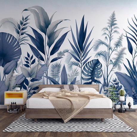 Blue Monstera leaf wallpaper creating a fresh tropical statement in a modern living room with white furniture