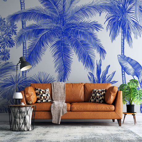 Blue palm trees tropical wallpaper mural styled in modern living room with white sofa and natural light