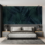 Tropical palm leaves wallpaper in modern living room with black sofa and natural light