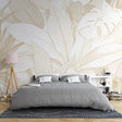 Tropical leaf wallpaper with white and gold design creating an elegant atmosphere in a modern living room