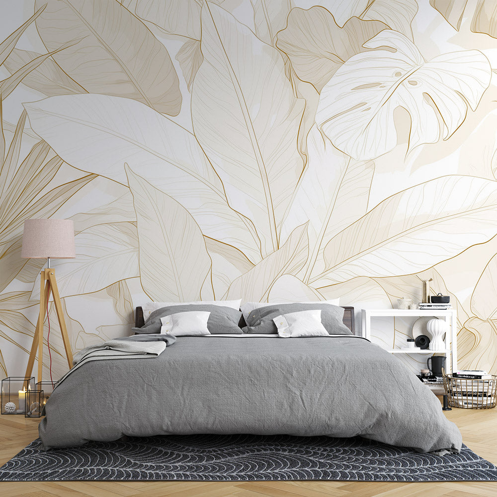 Tropical leaf wallpaper with white and gold design creating an elegant atmosphere in a modern living room