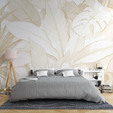 Tropical leaf wallpaper with white and gold design creating an elegant atmosphere in a modern living room