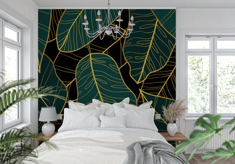 Tropical leaf wallpaper with gold accents in modern living room showing emerald green monstera pattern