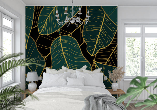 Tropical leaf wallpaper with gold accents in modern living room showing emerald green monstera pattern
